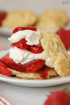 strawberry shortcakes with whipped cream and fresh strawberries on top are ready to be eaten