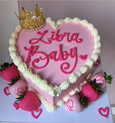 a heart shaped cake with pink frosting and hearts on it that says libra baby