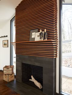 a fireplace with wooden slats on the mantle