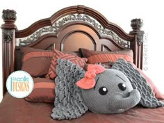 an elephant stuffed animal laying on top of a bed