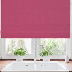 a pink roman blind in a kitchen window with potted plants on the windowsill