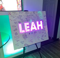 a white board with the word leah written on it next to a table in front of a door