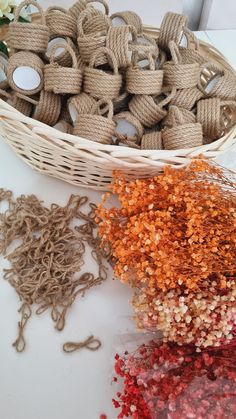 several different types of twine in a basket next to some other items on a table