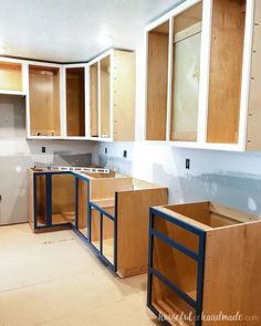 an unfinished kitchen with wooden cabinets in the process of remodeling