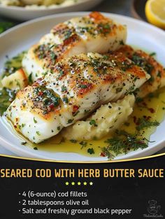 a white plate topped with fish covered in herbs