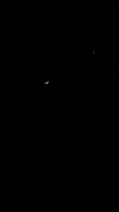 the moon is seen in the dark sky with only one light visible on it's side