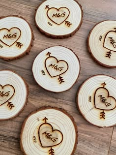 wood slices with carved hearts and arrows on them