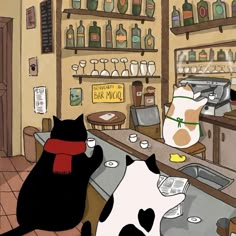 two black and white cats sitting at a bar