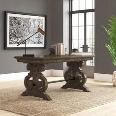 a wooden table sitting on top of a carpeted floor next to a potted plant