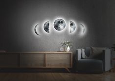 a living room with moon phases on the wall and a couch in front of it