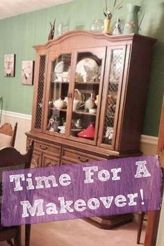 a wooden china cabinet sitting next to a dining room table