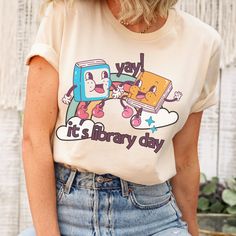 It's Library Day, Reading Shirt, Library Shirt, Funny Book Shirt, Bookish Tees, Librarian Gift, Library Shirts, Gift For Librarian back to school We add color and size charts to each for references so please make sure that you are selecting carefully. Once an order is received it goes into production and we are unable to cancel orders. ABOUT: :) A premium soft cotton blend UNISEX tee: This t-shirt feels comfy and light, with just the right amount of stretch and the unisex cut is flattering for b Cute Relaxed Fit Shirt For School, Bookish T-shirt With Funny Print For School, Bookish Short Sleeve Top For School, Bookish Graphic Print Tops For School, Bookish Cotton Tops For School, Short Sleeve Bookish Tops For School, School Tops With Graphic Print In Bookish Style, White Bookish T-shirt For School, Bookish Cotton Tops With Character Print