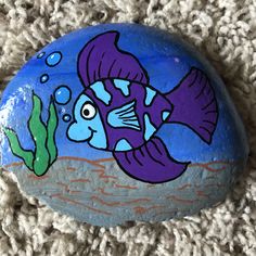 a painted rock with an image of a fish on it