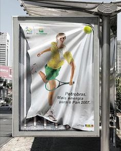 a billboard with a tennis player holding a racket and ball on it's side