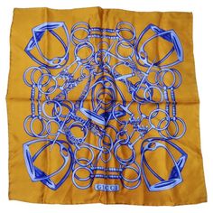 How incredible is this Gucci scarf circa 1980s?! A golden 100% silk contrasts vibrant shades of blue coming together to form a signature Gucci horse-bit motif. Notice how detailed this graphic is, it's truly a wearable work of art. Add the perfect touch of vintage to your look with this stunning pocket scarf! Wear this as a neck tie with a Moschino dress and some Chanel mules heels for and playful vintage-inspired look. In great vintage condition, please see photos. Made in Italy. Dimensions app Mules Chanel, Chanel Mules, Pocket Scarf, Mules Heels, Moschino Dress, Pocket Scarves, Gucci Scarf, Printed Scarf, Horse Bits