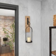 a wall mounted candle holder next to a brick wall