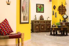 a living room with yellow walls and furniture