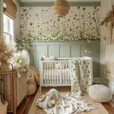 a baby's room with flowers on the wall, and a white crib