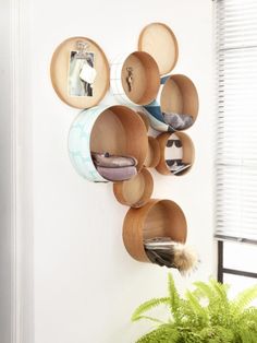 a wall mounted shelf filled with lots of plates and bowls on it's side