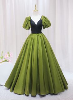 If your goal is to embody a blend of vintage charm and modern sophistication, this olive green prom dress is the quintessential choice. Perfectly capturing the essence of a timeless style with a contemporary twist, the dress features a bold black bodice that plunges into a deep V, framed by charming puff sleeves that add a whimsical touch. The striking contrast between the bodice and the vibrant green skirt creates a stunning visual balance. Crafted from luxuriously smooth fabric, the full skirt flows elegantly to the floor, ensuring every step you take is picture-perfect. Ideal for prom or any glamorous gathering, this gown combines the grandeur of old-world fashion with the sleekness of contemporary design, ensuring you stand out in the best way possible. Olive Green Prom Dress, Sky Blue Prom Dress, Sleeveless Prom Dress, Feather Prom Dress, Fashion Silhouette, Prom Dresses 2020, Stunning Prom Dresses, V Neck Prom Dresses