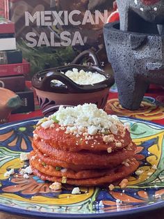 a plate with some food on top of it next to a book about mexican salsa