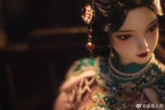 a close up of a doll wearing jewelry