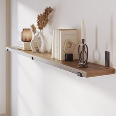 a shelf with books, vases and candles on it