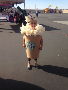 a young boy dressed as a starbucks drink costume