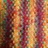 a close up view of a multicolored knitted blanket with stripes on it