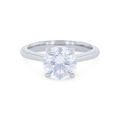 a round brilliant cut diamond engagement ring in 18k white gold, set with a tapered band