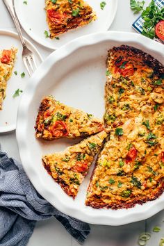 a white plate topped with a slice of frittata next to two slices of pizza