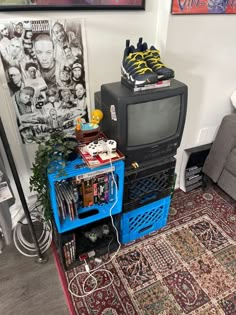 a television sitting on top of a blue cart