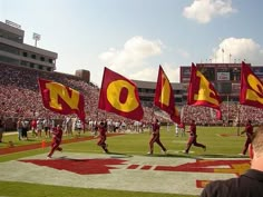 some people are running on a field with flags