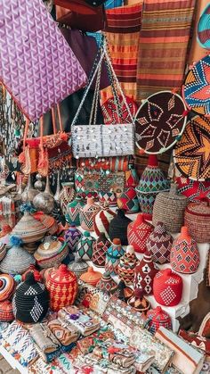 colorful baskets and other items for sale at an outdoor market stall in the mexican city of santa fez, mexico