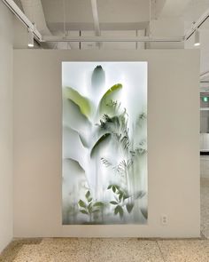 an abstract painting is displayed on the wall in a white room with tile flooring