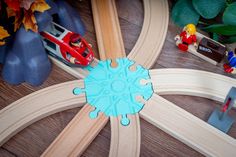 a toy train set with wooden tracks and cars