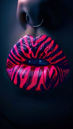 a woman's lips are painted with pink and black lipstick, while the image is in