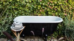 an old fashioned bathtub in the middle of a garden