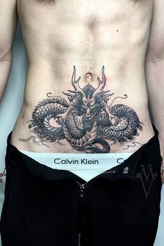 a man with a dragon tattoo on his stomach