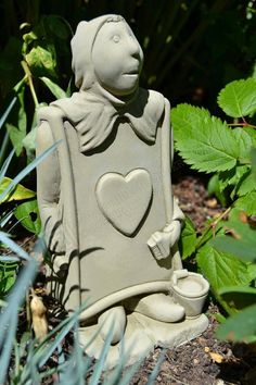 a small statue with a heart on it