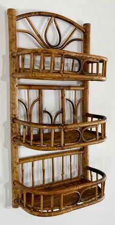 a bamboo shelf with three baskets on it