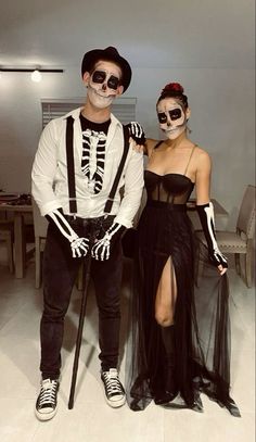 a man and woman in skeleton costumes standing next to each other