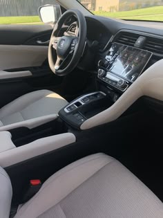 the interior of a car with dashboard, steering wheel and infotains on display