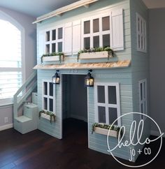 a doll house with windows and shutters on the top floor in a child's room