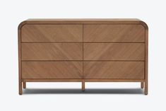 the chest of drawers is made from wood and has an angled design on one side