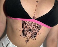 a woman's stomach with a butterfly tattoo on her belly and the bottom part of her abdomen