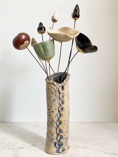 a vase filled with lots of different types of rocks