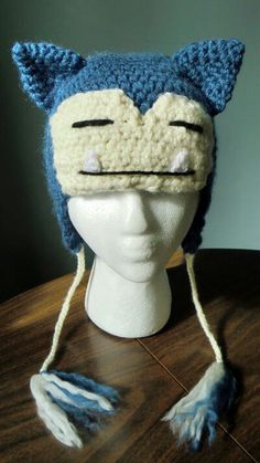 a crocheted cat hat on top of a mannequin head