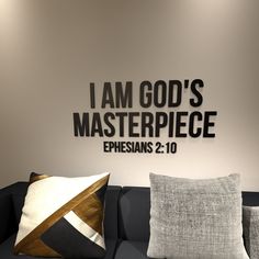 a living room with a couch, pillows and a wall that says i am god's masterpiece