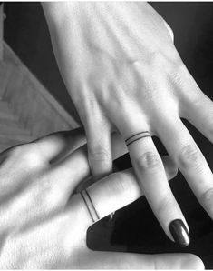 two people with wedding rings on their fingers